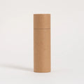 A tall, cylindrical, brown paper tube stands against a white background, exemplifying eco-friendly packaging with its simple, unadorned, and recyclable material design.