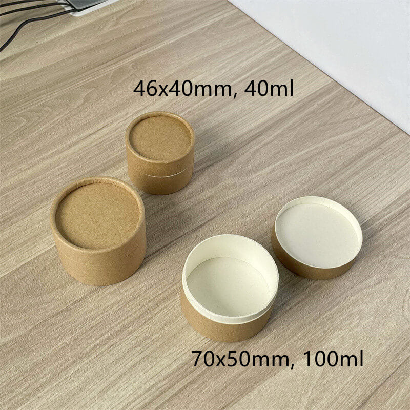 Brown paper tubes with measurements and capacity labels, some closed and one open, displayed on a wooden surface.